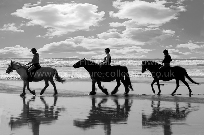 RIDING ON THE BEACH AT DRUIDSTON WALES UK
